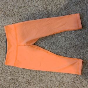 Orange Lululemon crop yoga pants